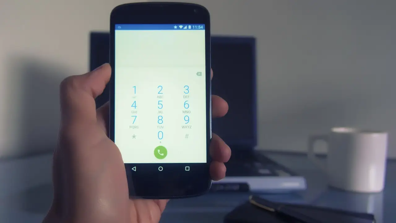 A hand tapping the Force stop button on an app's info screen in Android Settings.