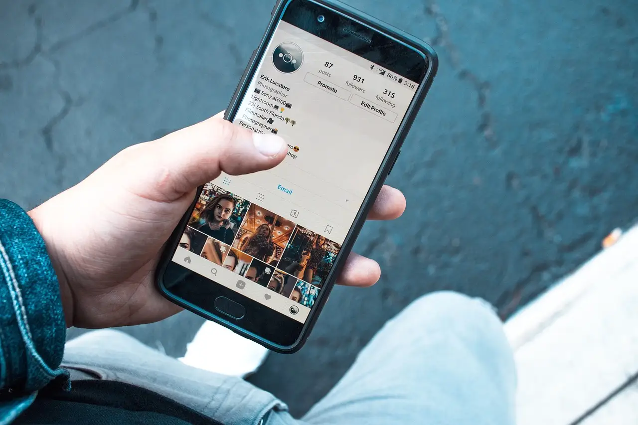A hand using a smartphone touchscreen